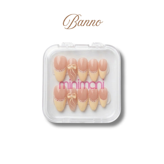 Minimani Banno press-on nail set, almond nails with yellow lace French tips and 3D bow