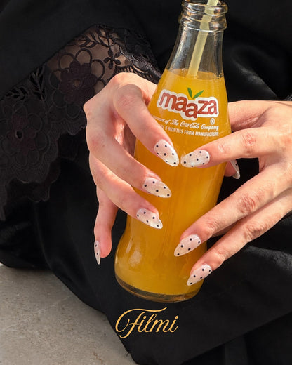 Minimani Filmi polka dot press-on nails on hand, close-up