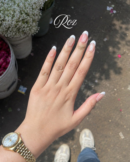 Minimani Roz French tip press-on nails worn on hand