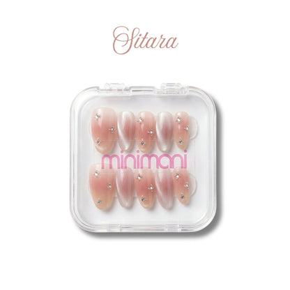 Minimani Sitara press-on nail set, blush pink almond nails with star rhinestones and cat-eye accents