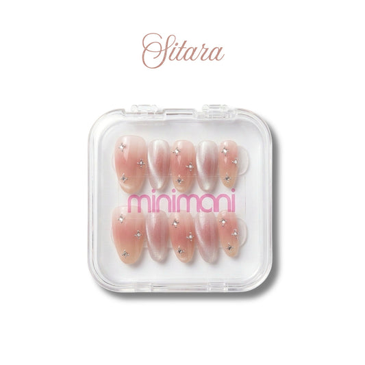 Minimani Sitara press-on nail set, blush pink almond nails with star rhinestones and cat-eye accents