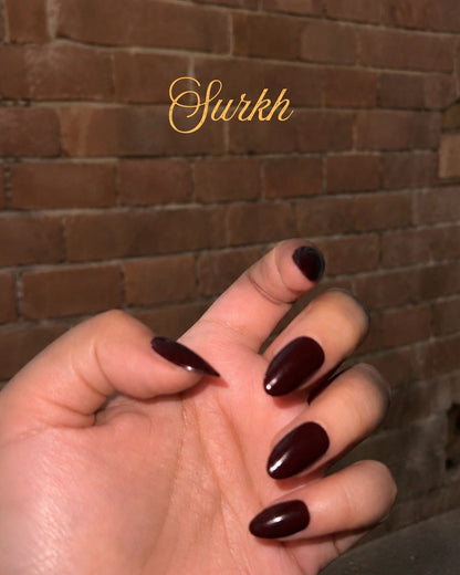 Minimani Surkh red press-on nails worn on hand